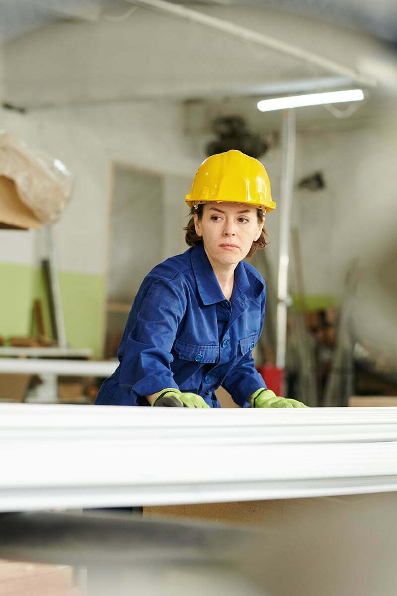 Yellow Helmet Female Employee Ensuring Safe and Trouble-Free Transportation Services
